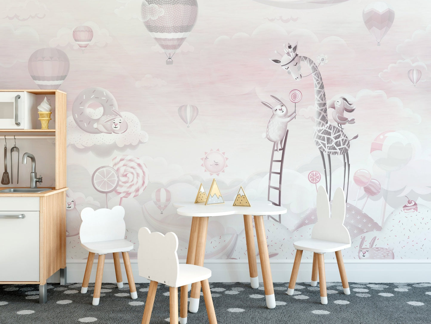 Small dining desk for kids with a pink cartoon wall mural background.
