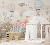 Pink circus wall mural showcasing joyful scenes in kids playroom.