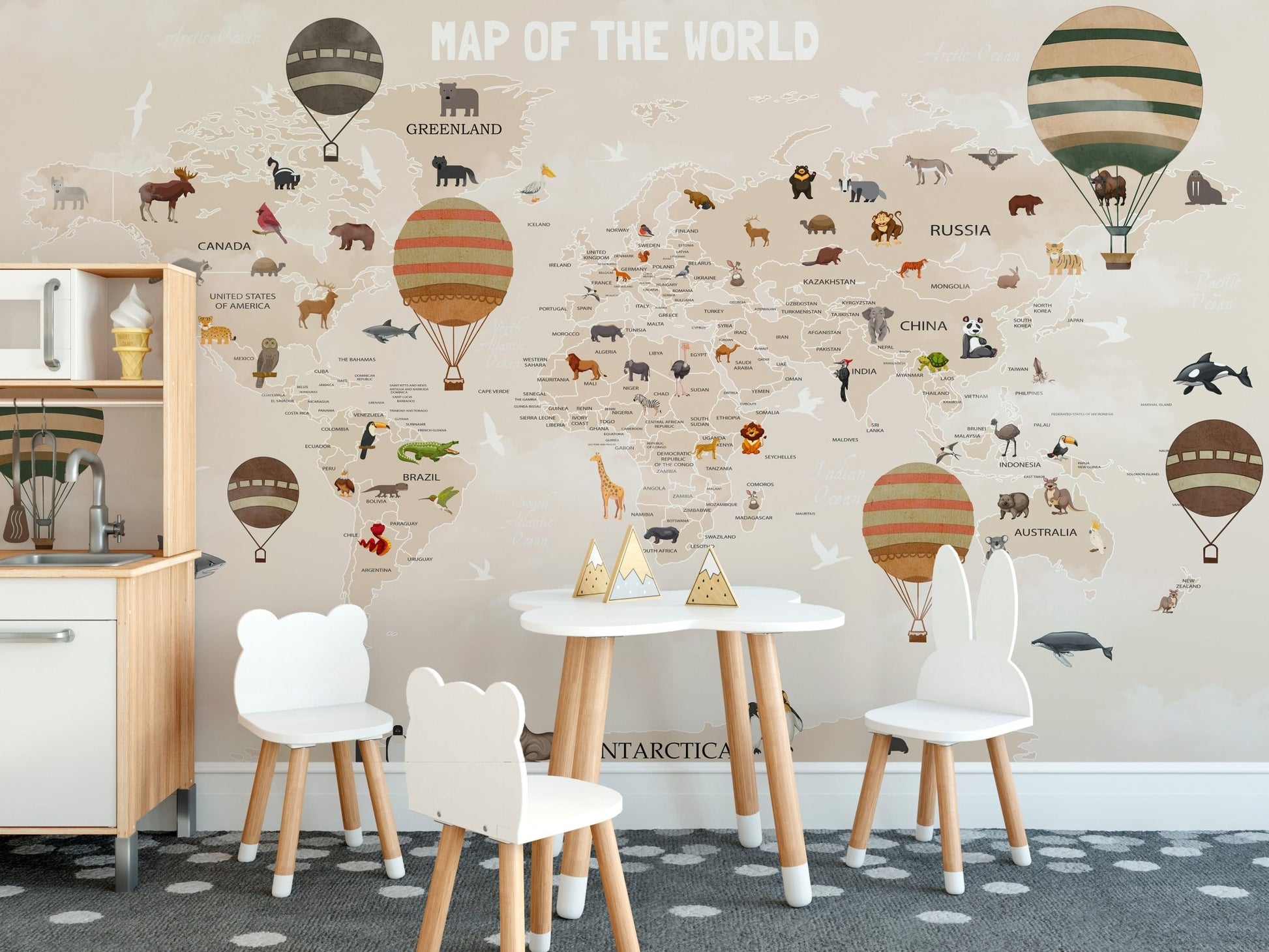 Dining area with a small white table and a world map wall mural.