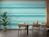 Teal wavy stripe wallpaper in a dining area with wooden furniture