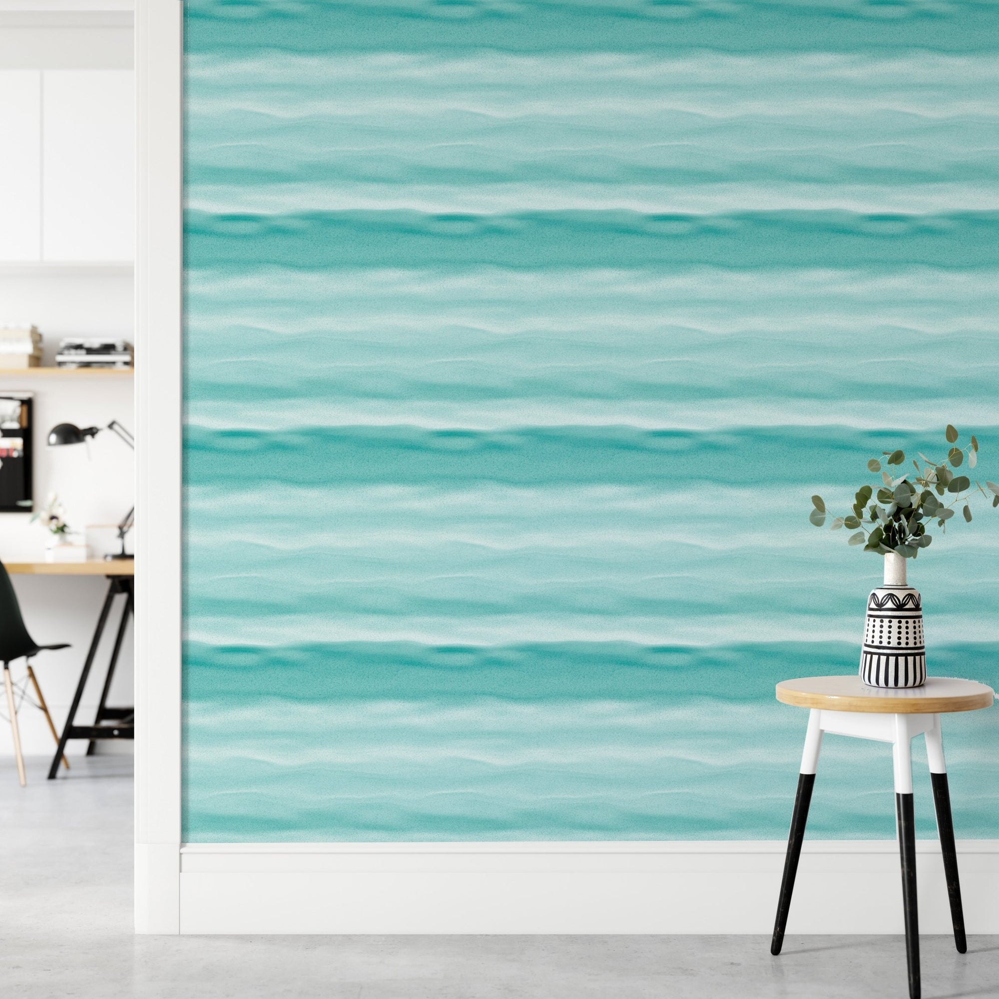 Teal blue wavy stripe wallpaper in a home office with wooden desk