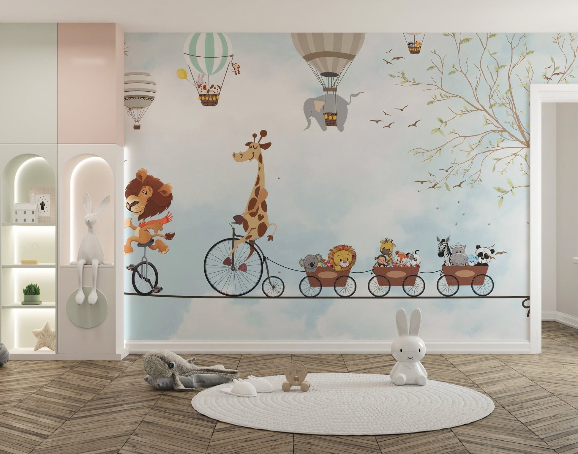 Giraffe on a bicycle acrobats wall mural for a nursery with a white rug and play area.