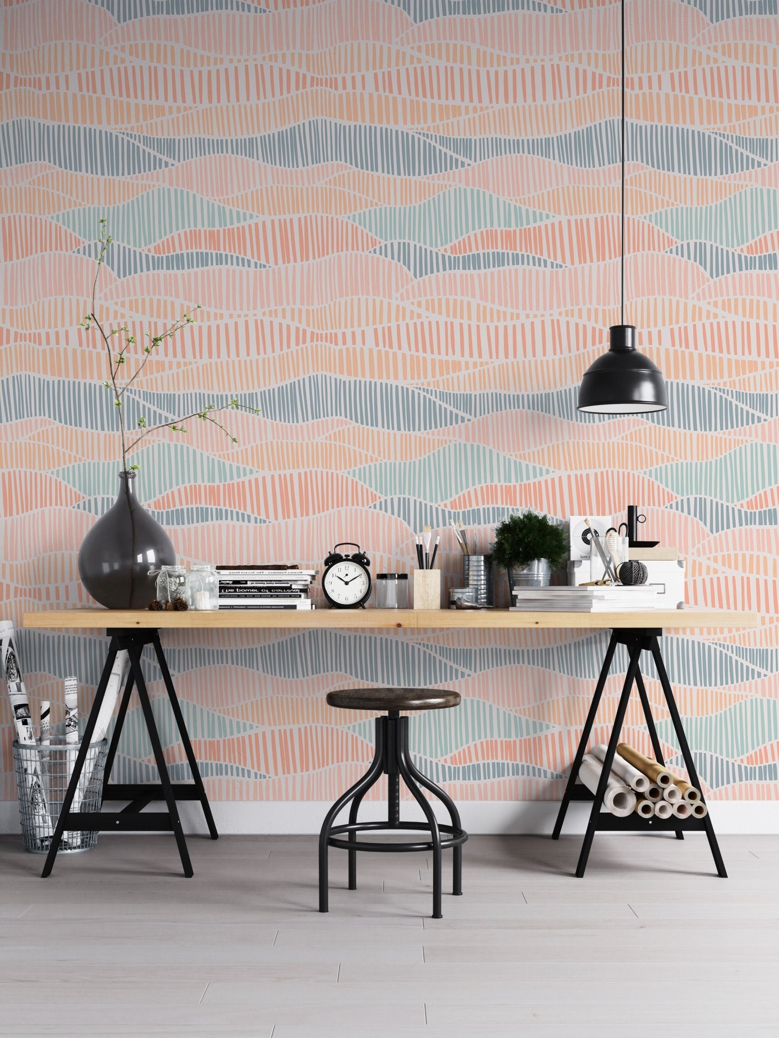 Hand drawn wallpaper behind a black desk with an industrial stool and lamp.