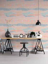 Hand drawn wallpaper behind a black desk with an industrial stool and lamp.