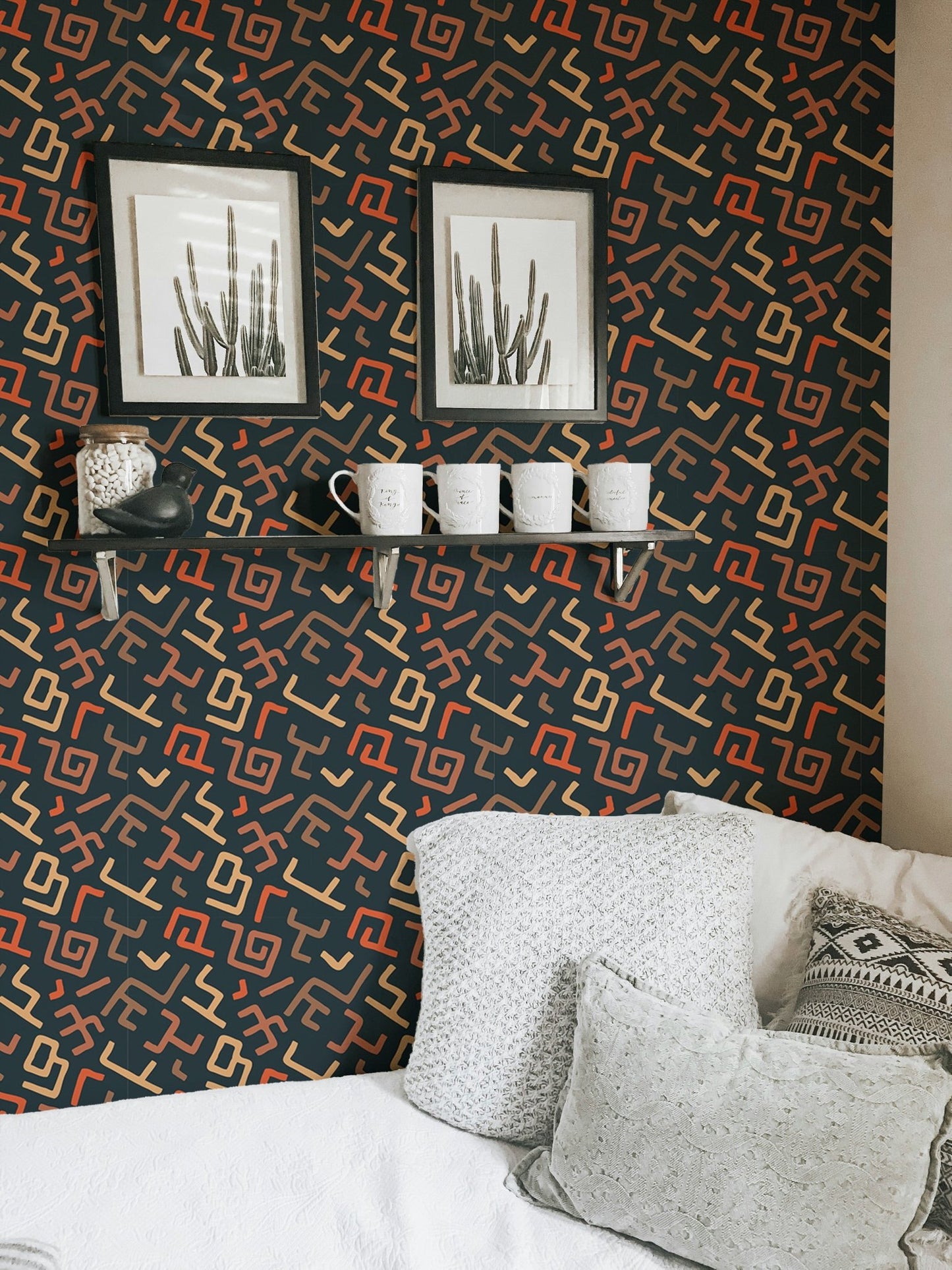 Living room wall with patterned wallpaper behind white sofa.