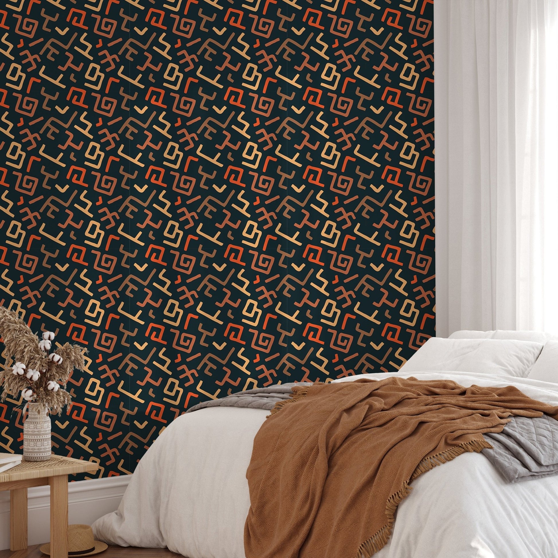 Bedroom corner showing dark tribal wallpaper with brown textile accents.