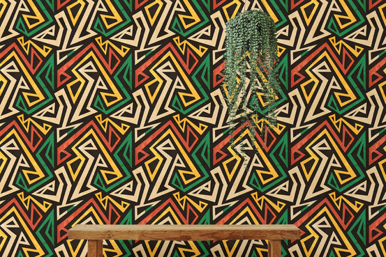Wooden console table and hanging plant by an African geometric effect wallpaper.