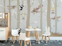 Panda themed wall mural in a toddler room with a small wooden table and chairs.