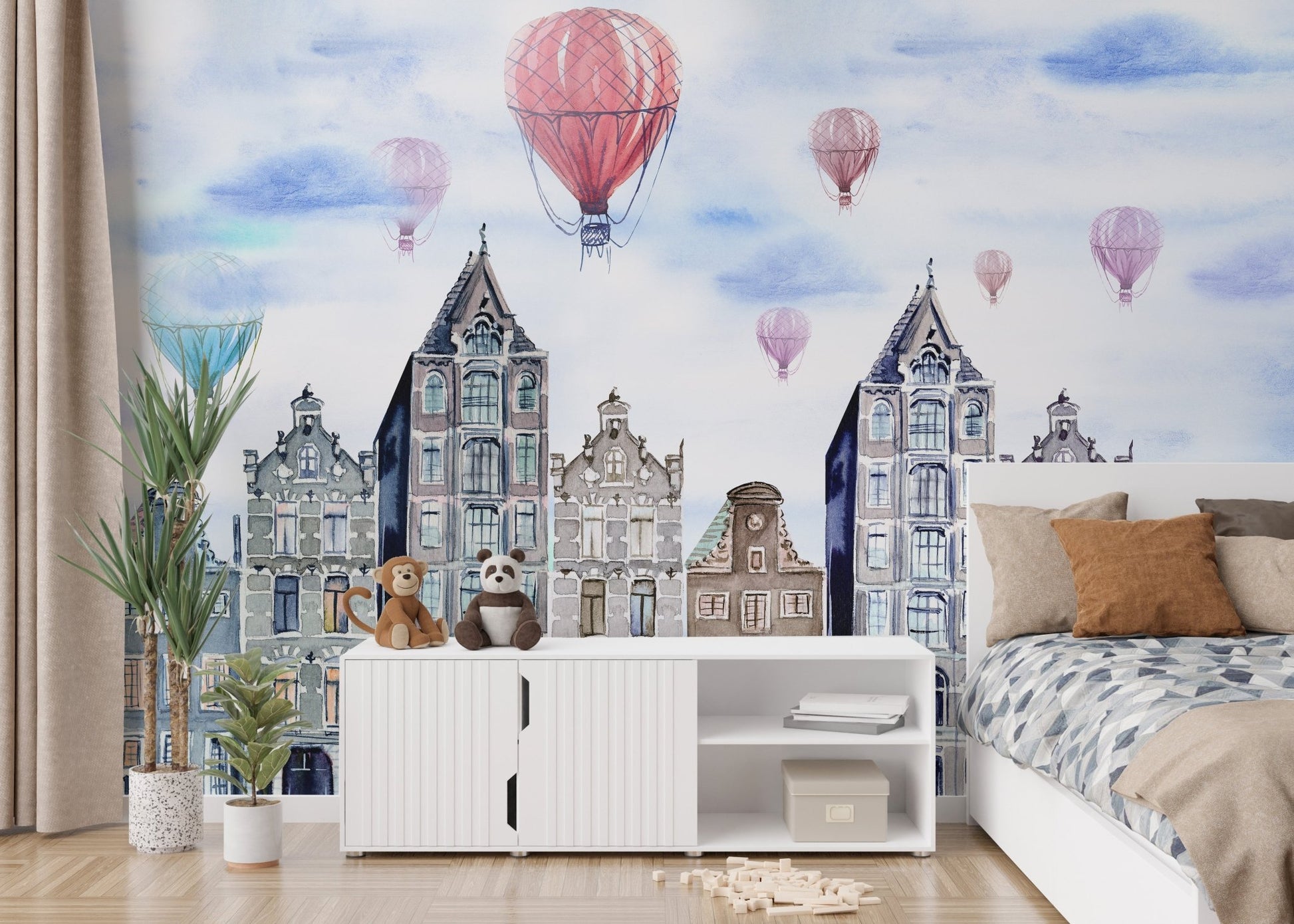 Cityscape wall mural featuring blue gabled houses and red hot air balloons in a bedroom.