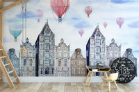 Amsterdam Hues Watercolor Cityscape Mural in a study area with small wooden chairs.