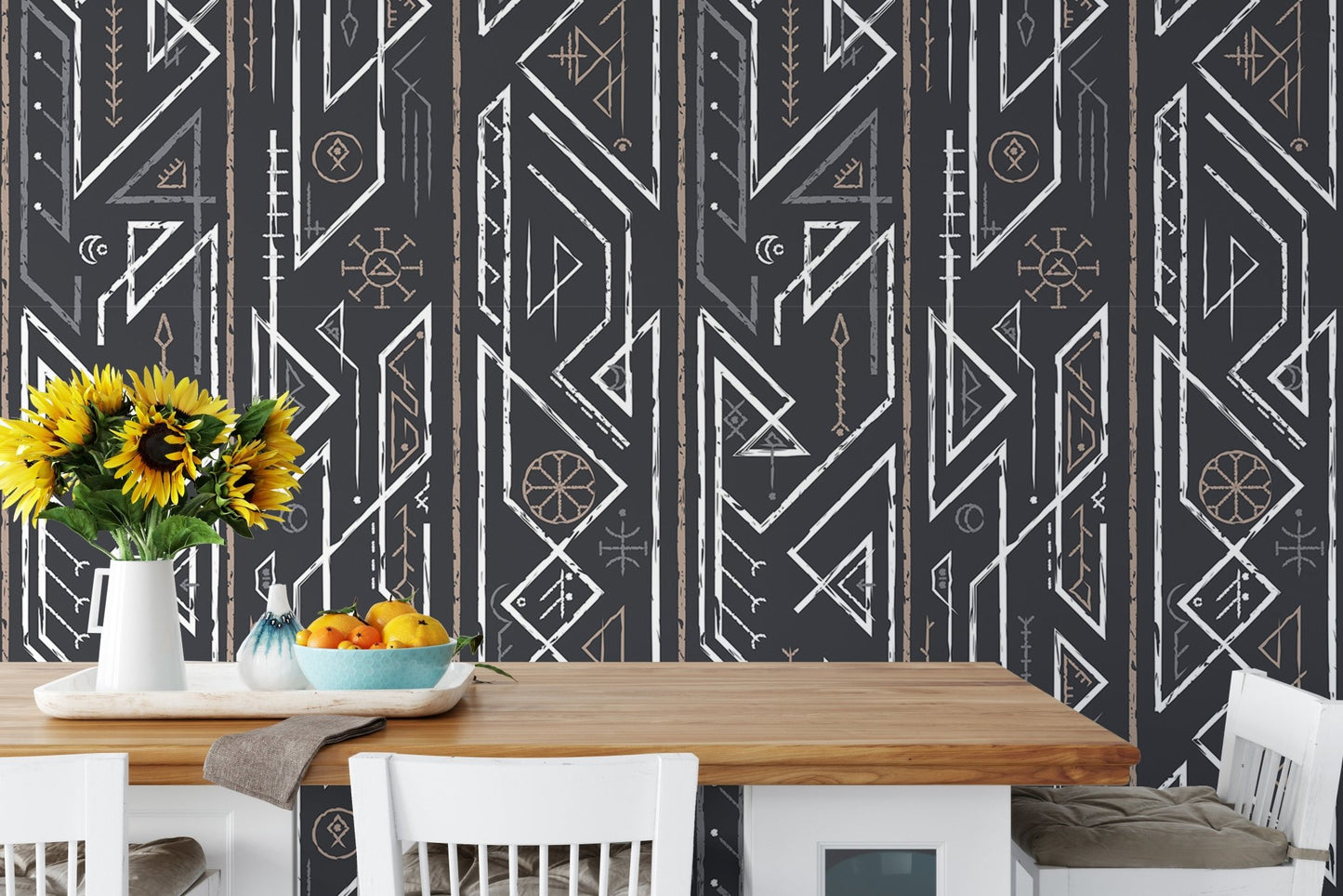 Dining area with yellow flowers on the table and geometric wallpaper.