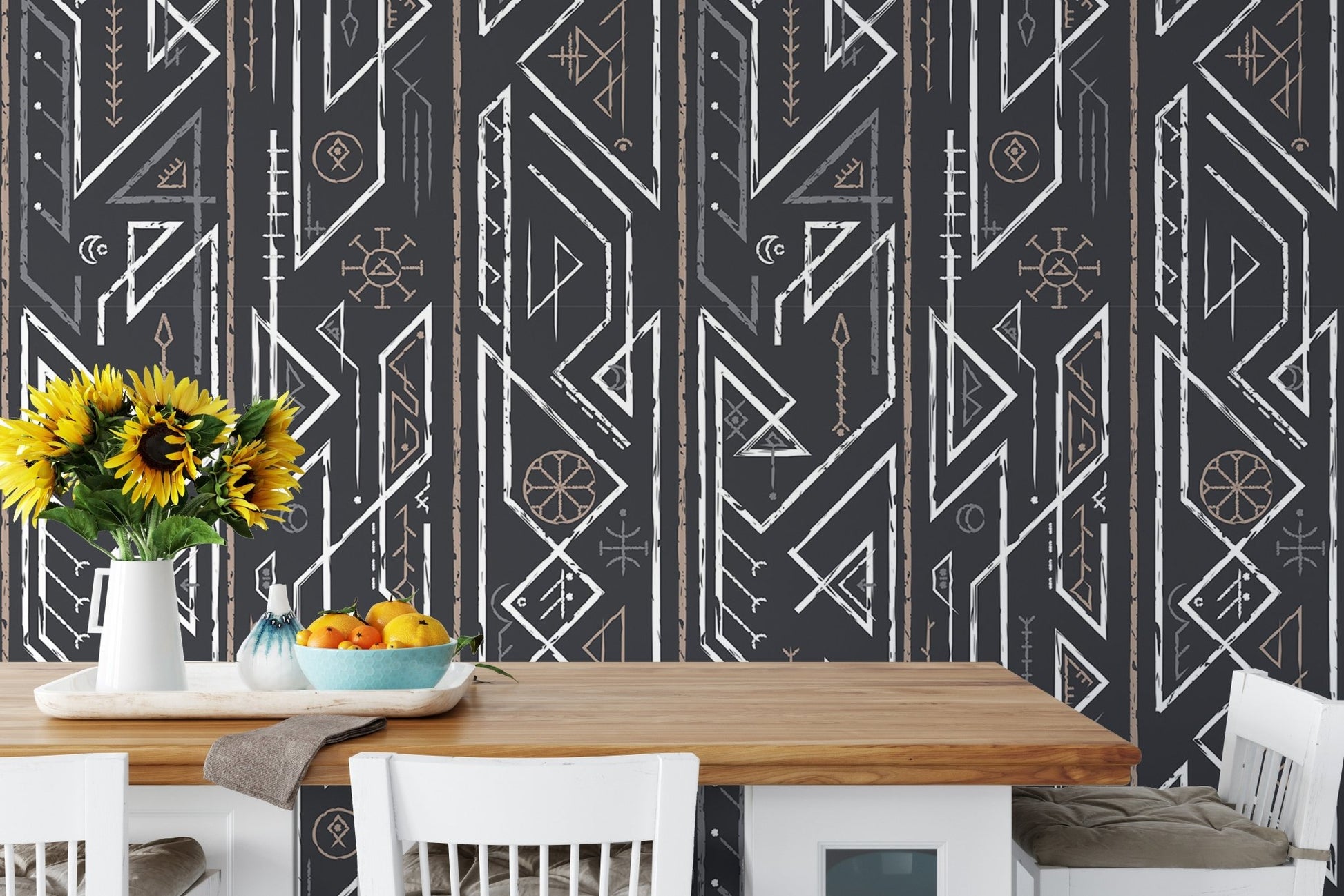 Dining area with yellow flowers on the table and geometric wallpaper.
