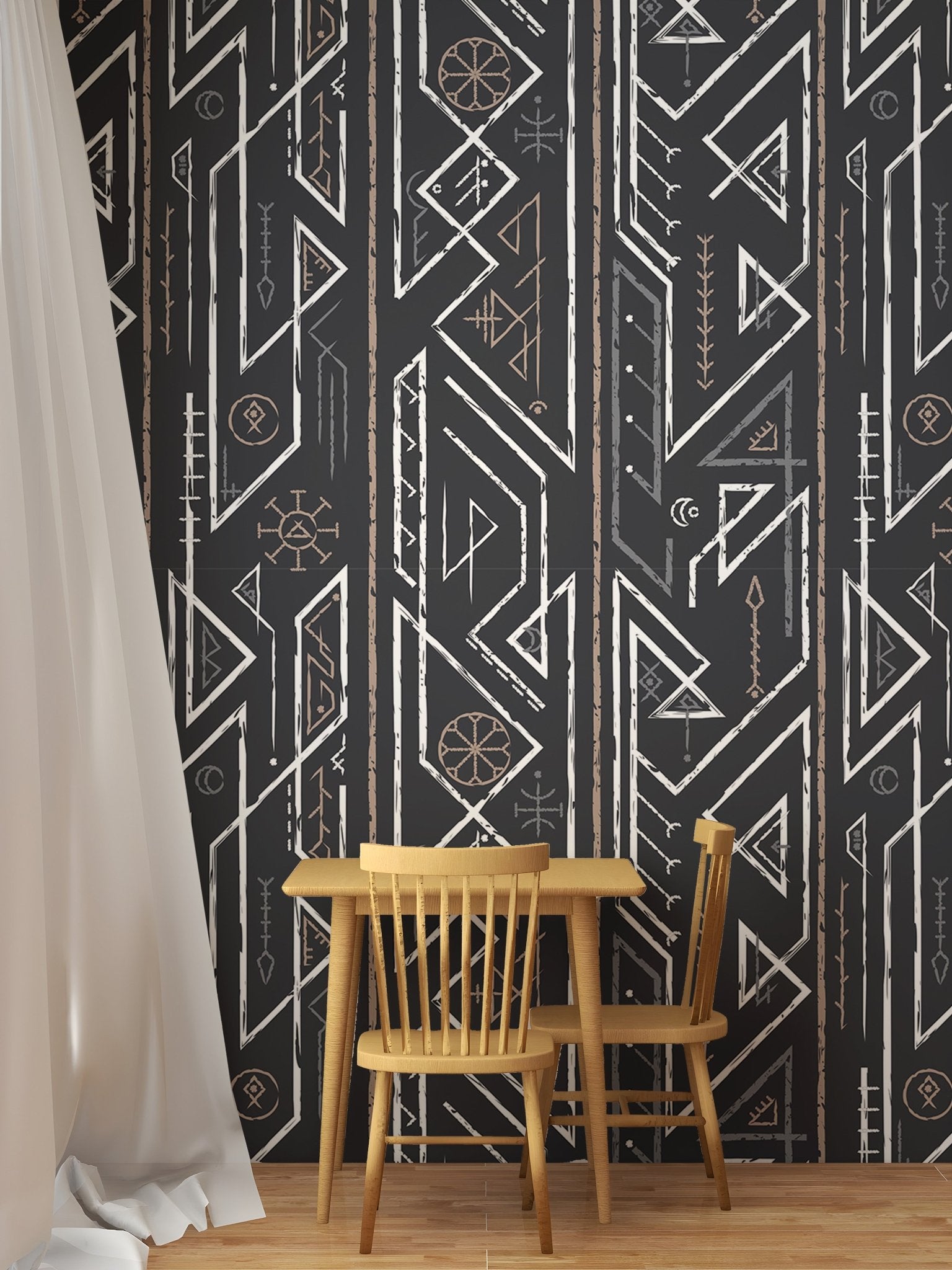 Small wooden dining table and chairs set against dark grey pattern wallpaper.