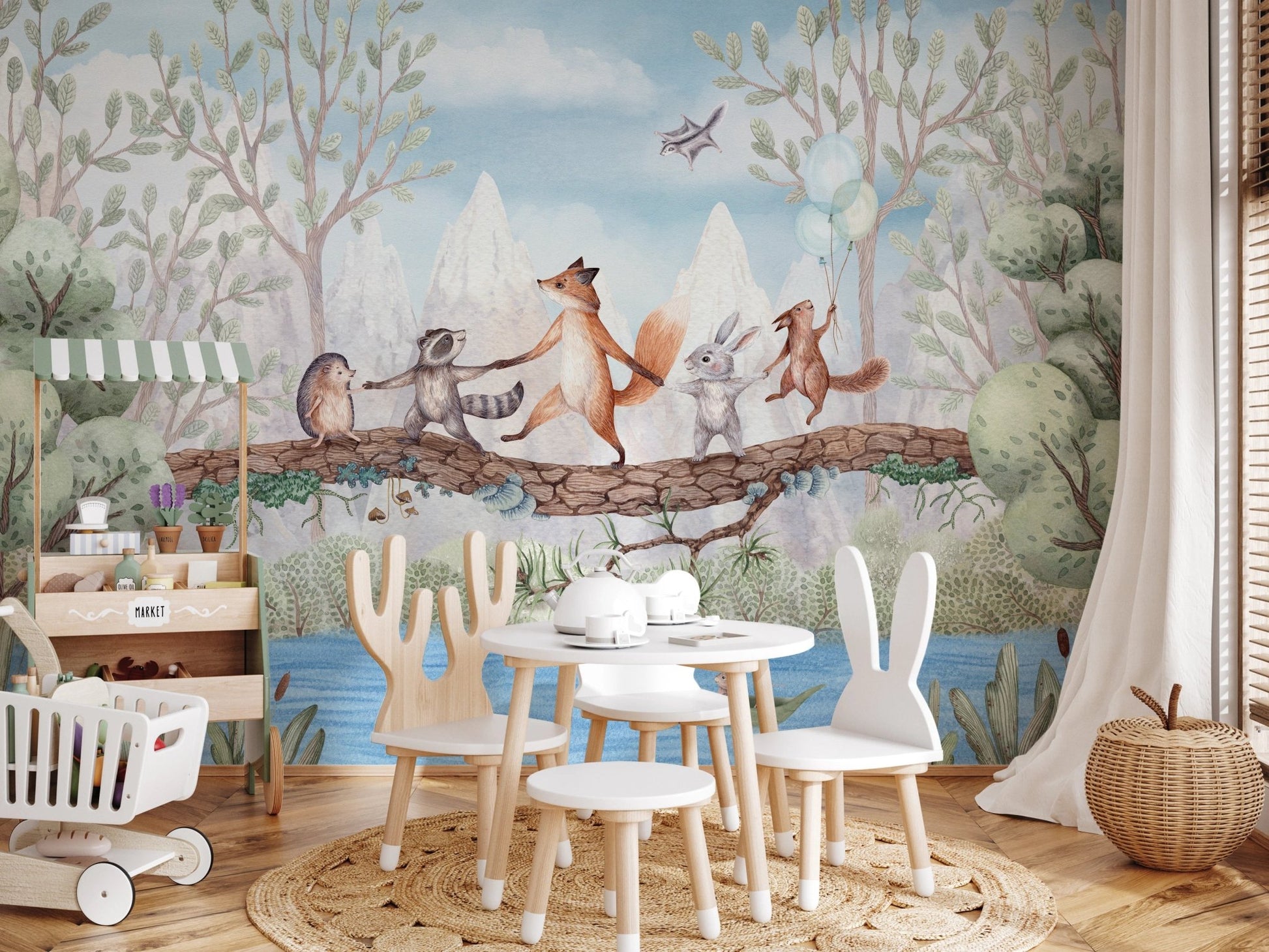 Play area with white rabbit chairs and a forest animal wall mural.