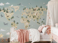 Soft pink bedding and white dresser against a blue world map wall mural.