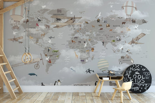 Children's activity area with a small table and world map wall mural.