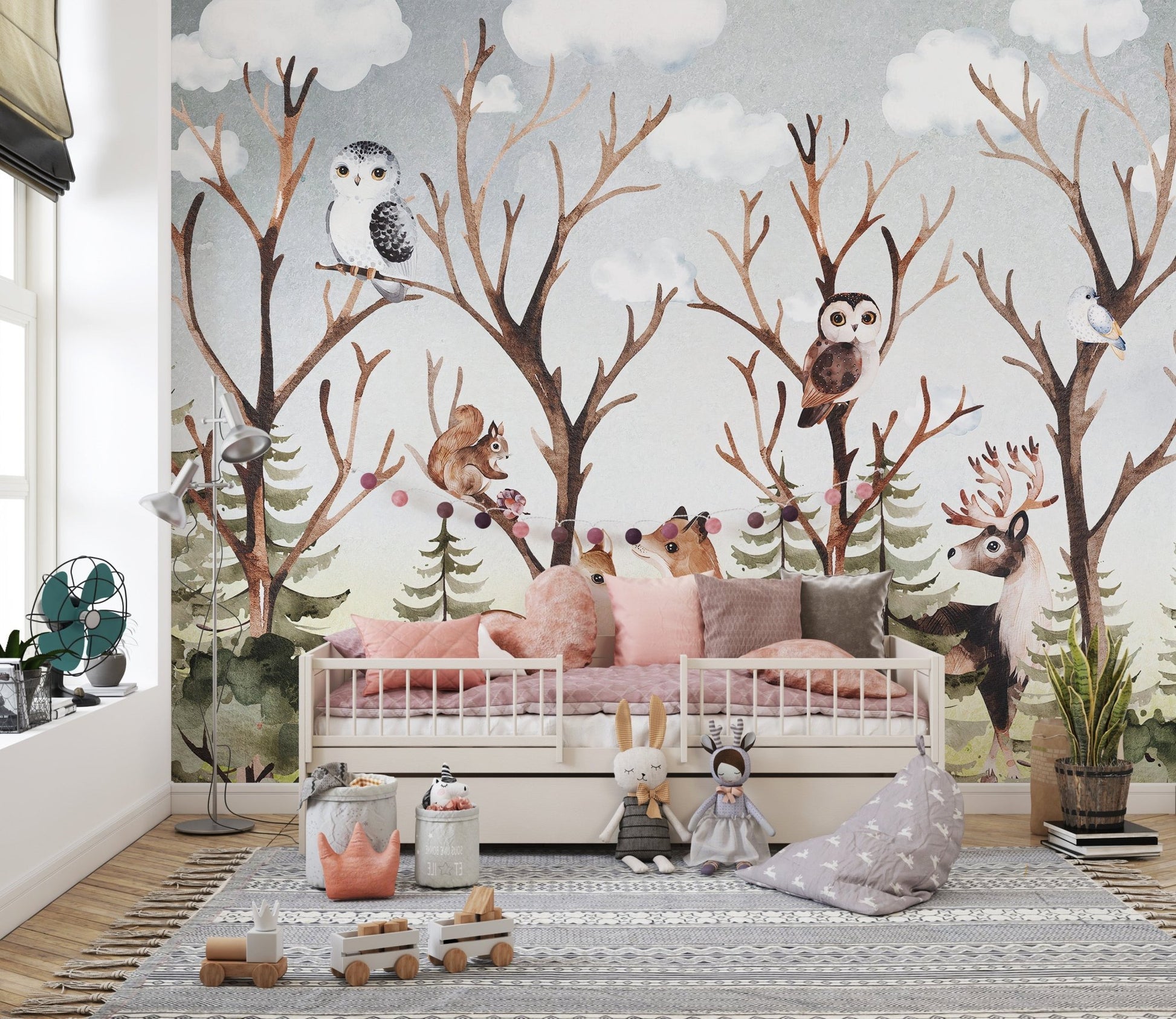 Brown forest animal wall mural behind a white toddler bed and grey rug.