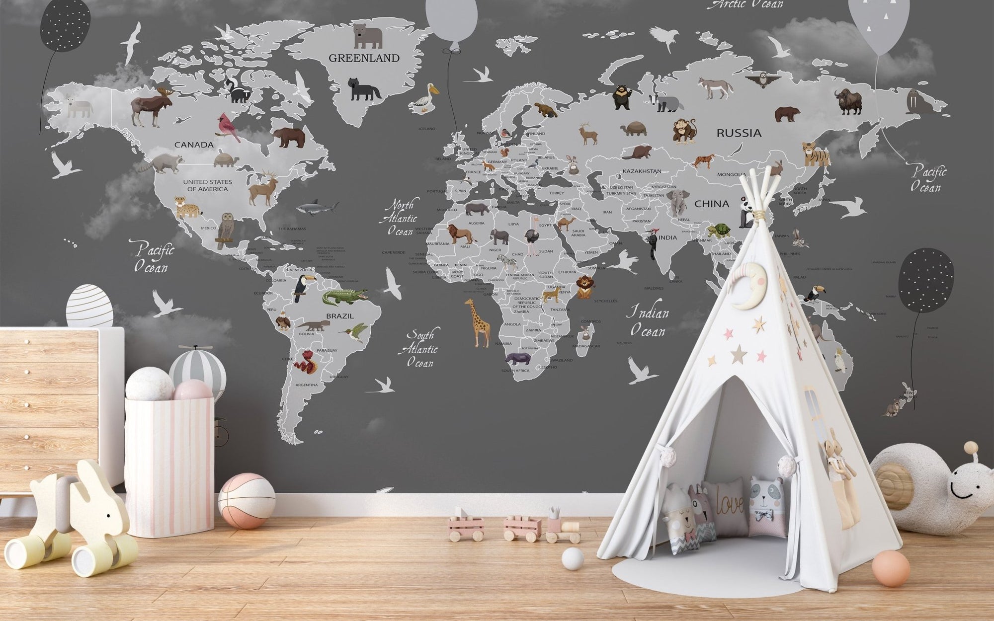 Grey world map wall mural with white teepee and wooden floors in a playroom.