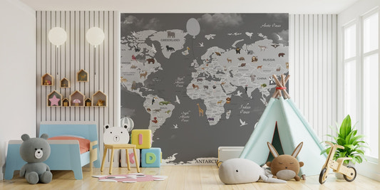 Animals world map mural behind a blue sofa and white toy storage unit.