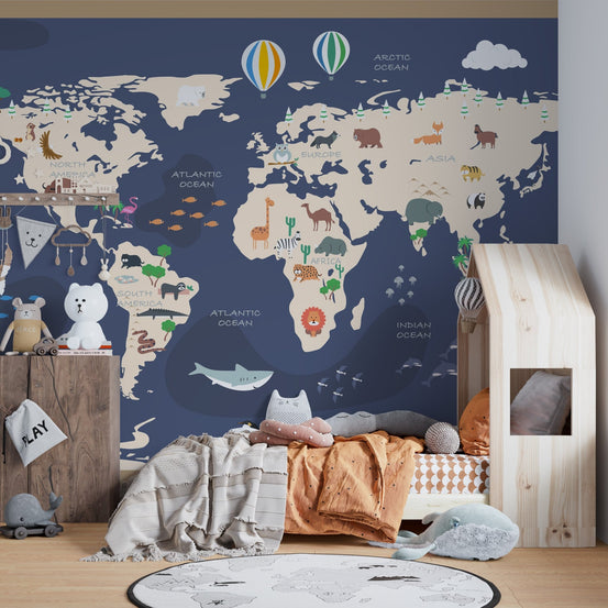 Animated World map wall mural with animals in a kids bedroom featuring a wooden house bed.