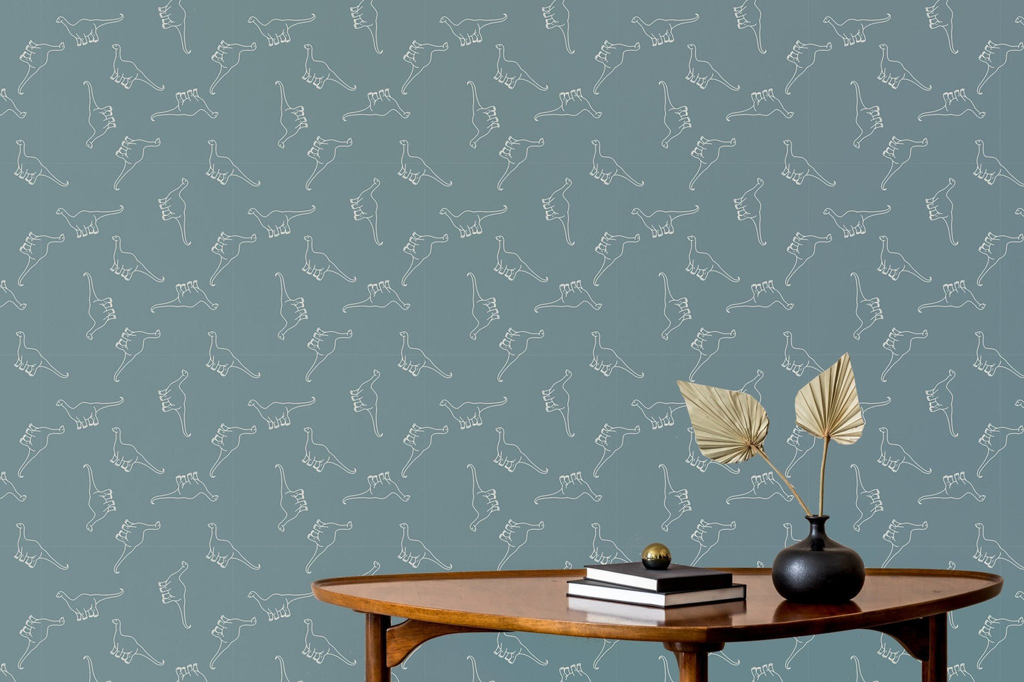 Minimalist living space featuring a teal dinosaur wallpaper and a mid-century coffee table.