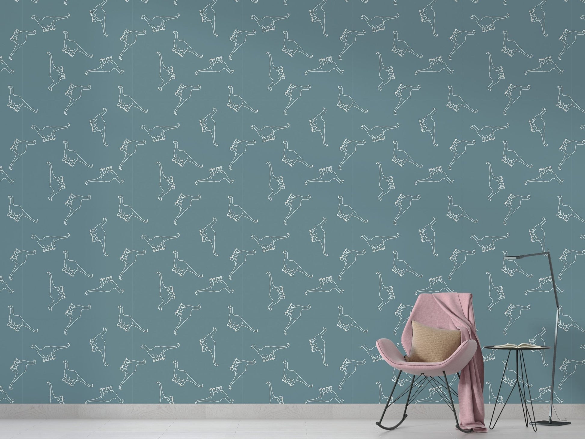 Modern living room with teal Apatosaurus dinosaur pattern nursery wallpaper and a pink chair.