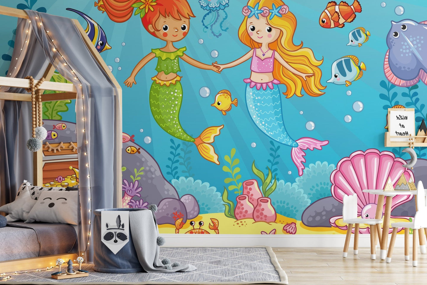 Kids' bedroom with a grey rug and illustrated mermaid mural on the wall.
