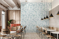 Restaurant dining area featuring aqua floral wallpaper.