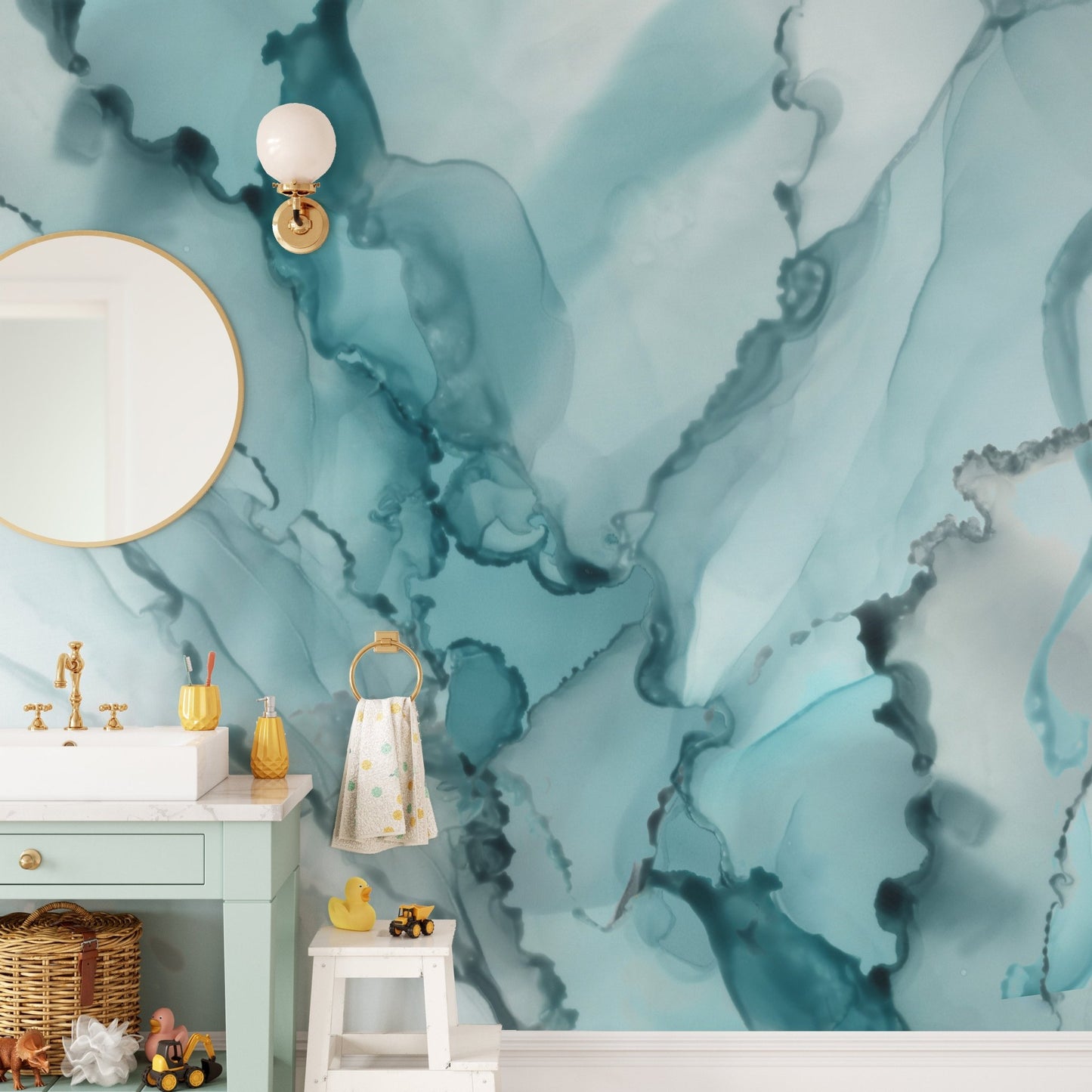 Blue liquid marble wall mural behind a white pedestal sink and round mirror.