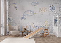 Narwhal and friendly fish playing in bubbly waters on a kids' ocean mural.
