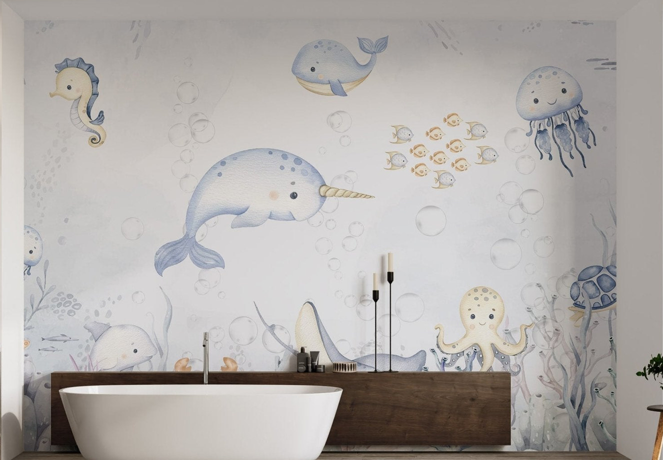 Playful narwhal swimming among sea creatures in underwater kids wall mural.