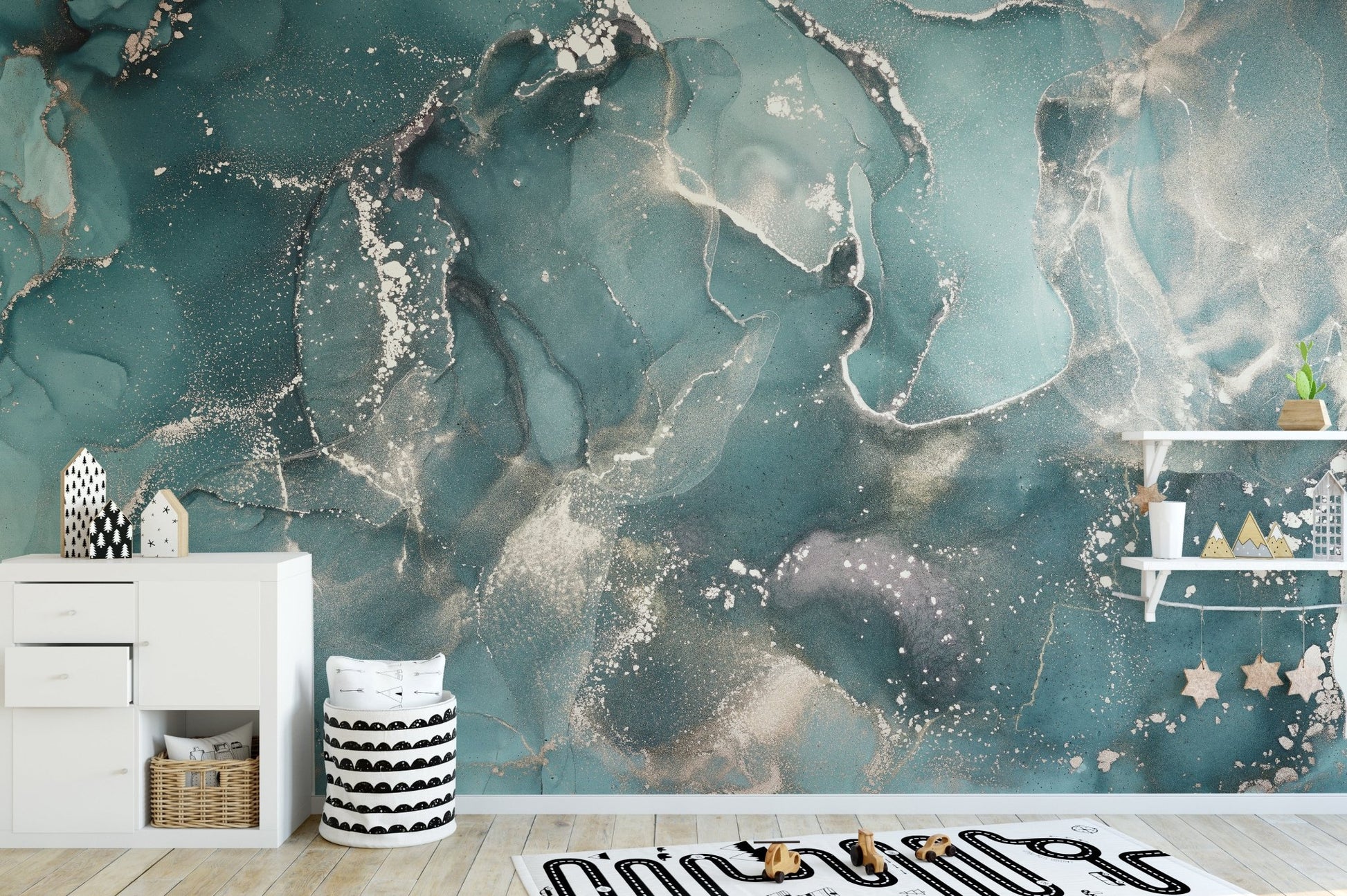 Marbled teal wall mural in a minimalist kids room with white cabinets.