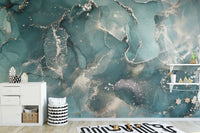 Marbled teal wall mural in a minimalist kids room with white cabinets.