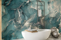 Fluid ink marble wall mural pattern in a bathroom with gold fixtures.