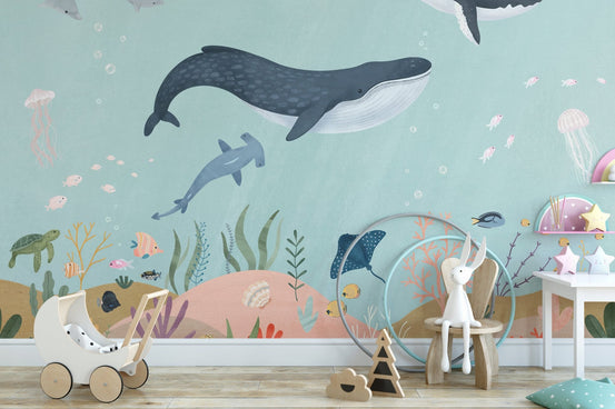 Aquatic wonders wallpaper mural with whales in soft teal ocean tones.