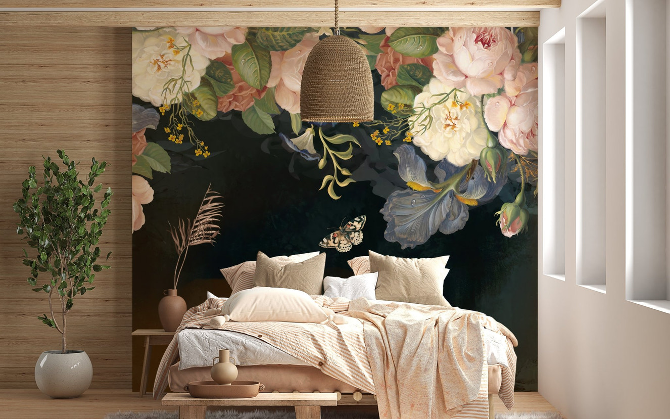 Moody flower wall mural behind a white bed with neutral pillows in bright bedroom.