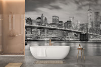 Brooklyn Bridge wall mural as a backdrop in a contemporary bathroom with a white tub.