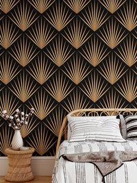 Black and gold geometric wallpaper behind wooden chair and side table.