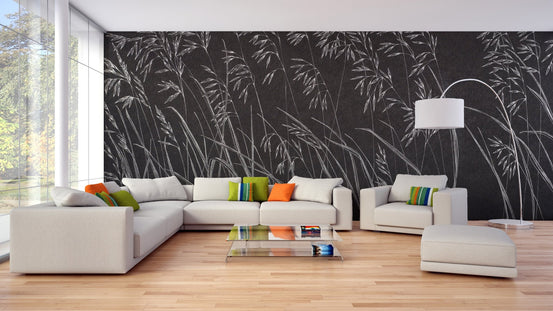 Large living room featuring black botanical leaves wall mural and white sectional sofa.