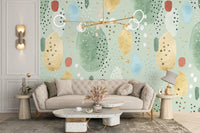 Contemporary sofa set against a light green wall mural backdrop.