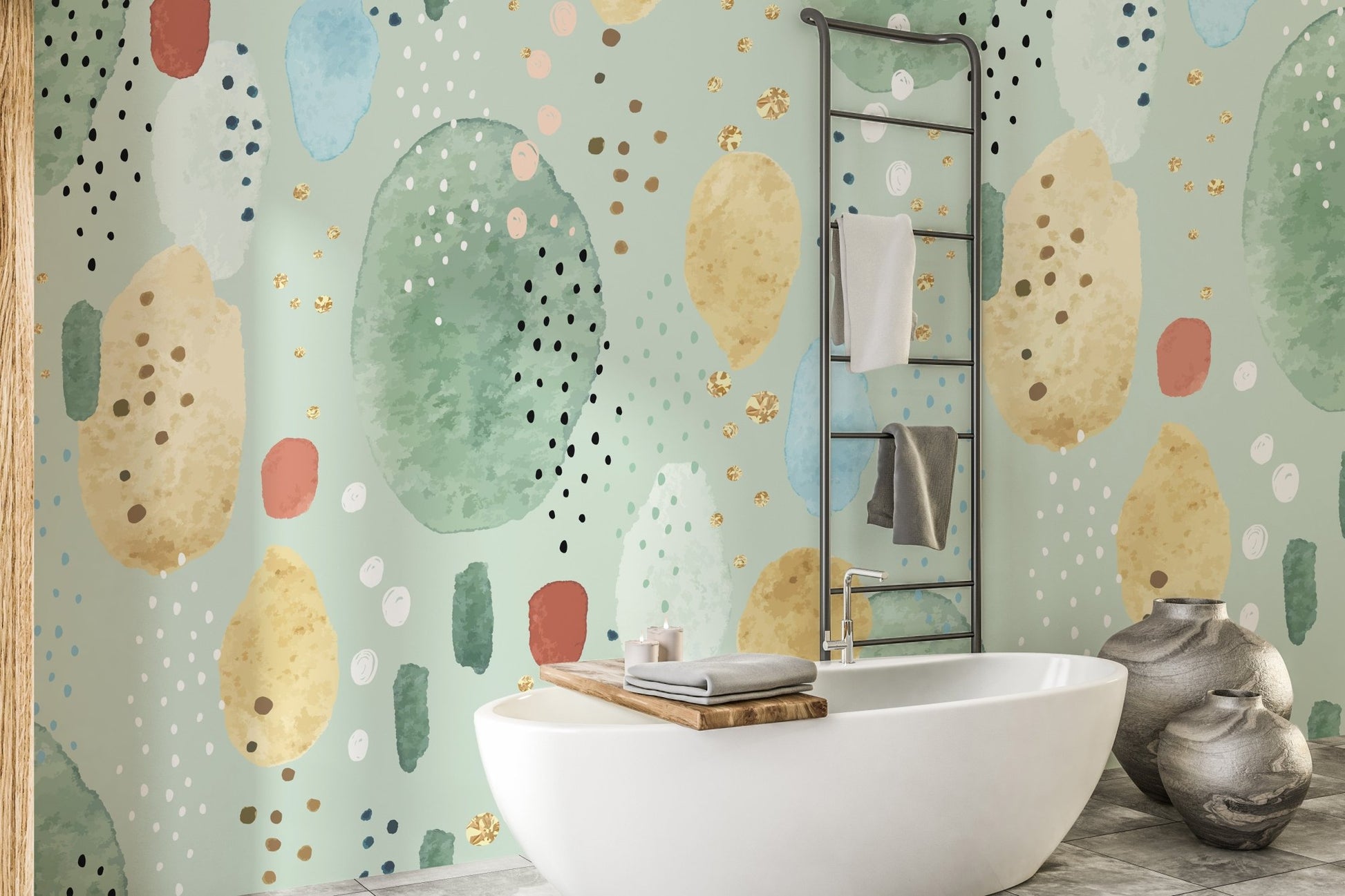 Abstract green and gold shapes wall mural behind a white bathtub.
