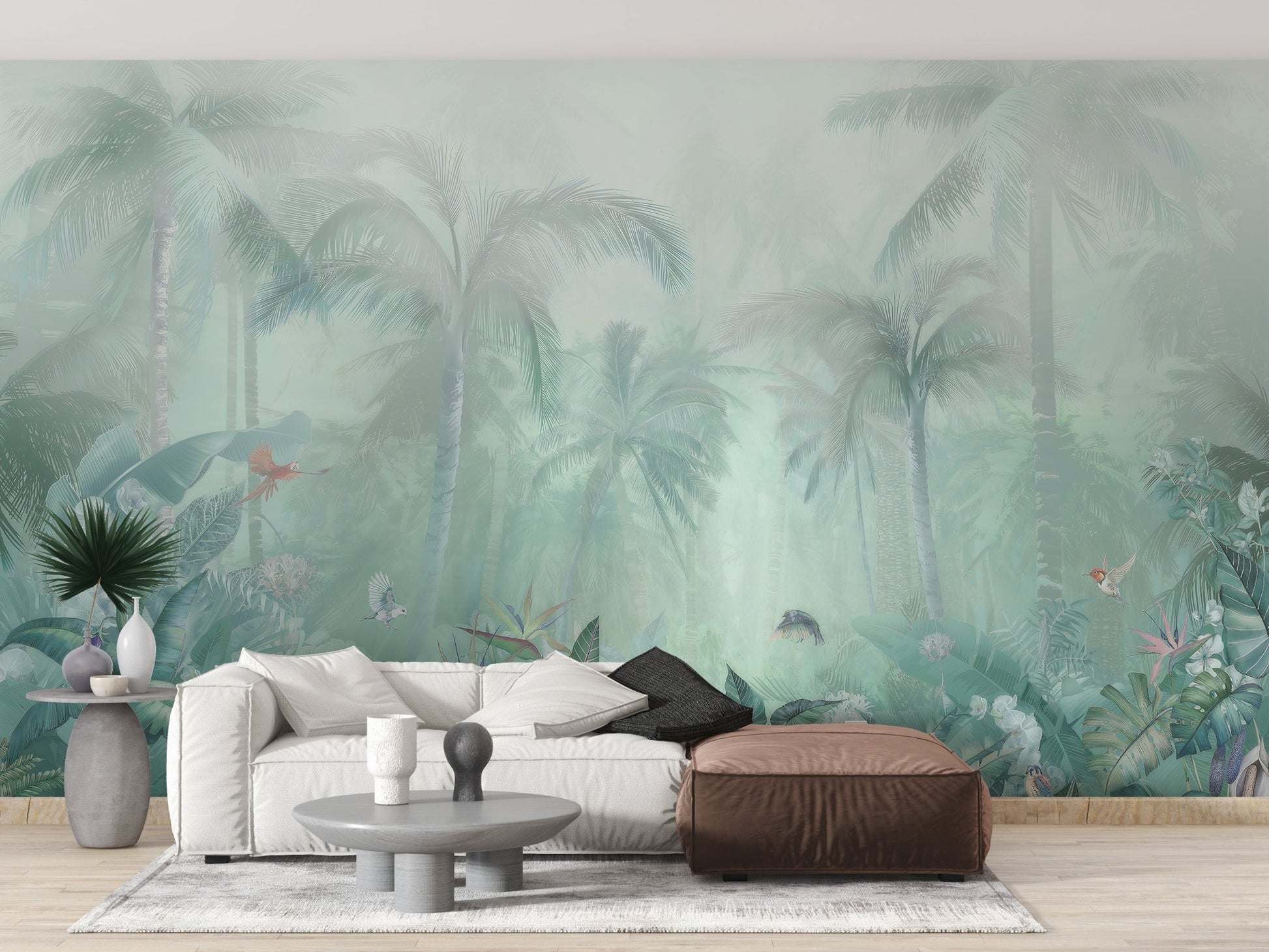 Faded forest leaf wall mural in a living area with a brown leather ottoman.