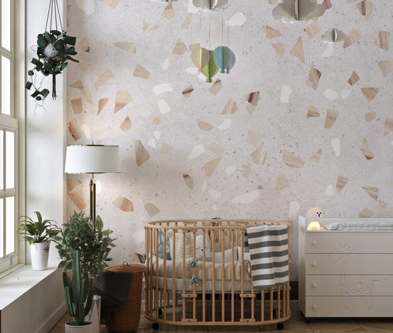 Artistic Terrazzo Marble Wall Mural in a nursery with a wooden crib.