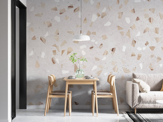 Modern terrazzo wall mural behind a minimalist wooden dining set.