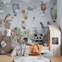 Children's bedroom with elephant and giraffe art wall mural and wooden decor.