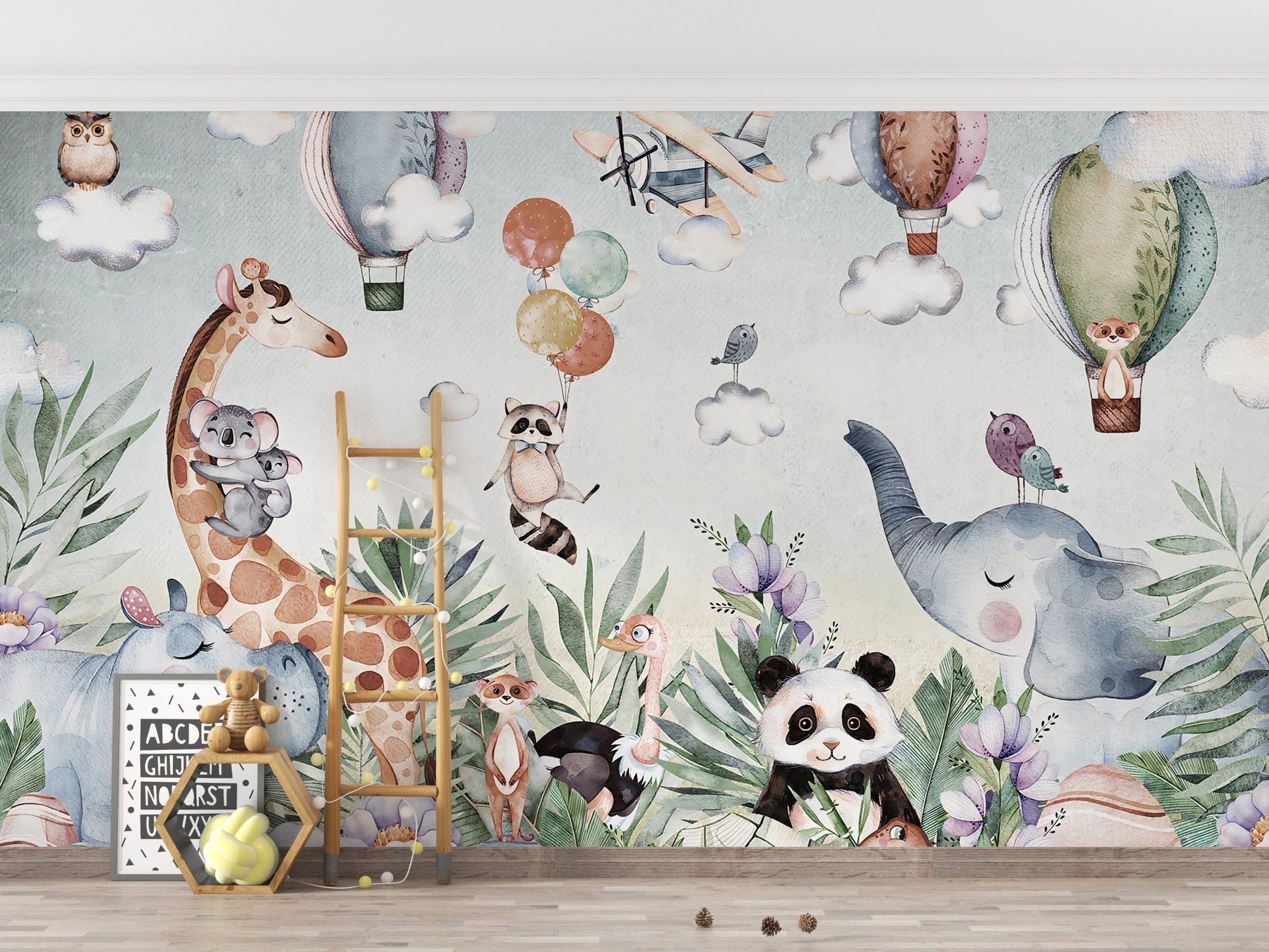 Nursery room featuring a light blue wildlife hot air balloon wall mural.