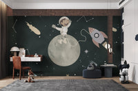 Whimsical space mural with a monkey  and a rocket for kids study room.