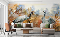 Minimalist living area featuring crane birds wall mural in orange and blue.