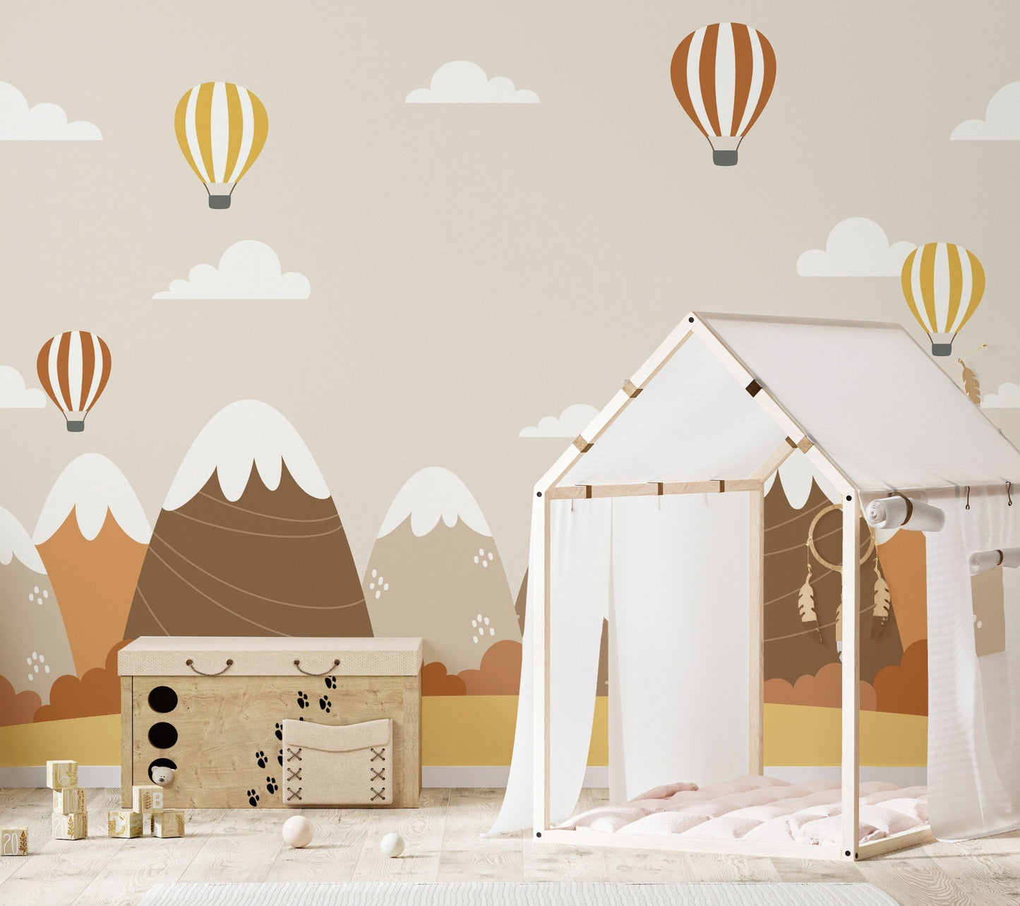 Fall-themed wallpaper mural with hot air balloons and foliage on kids room wall.
