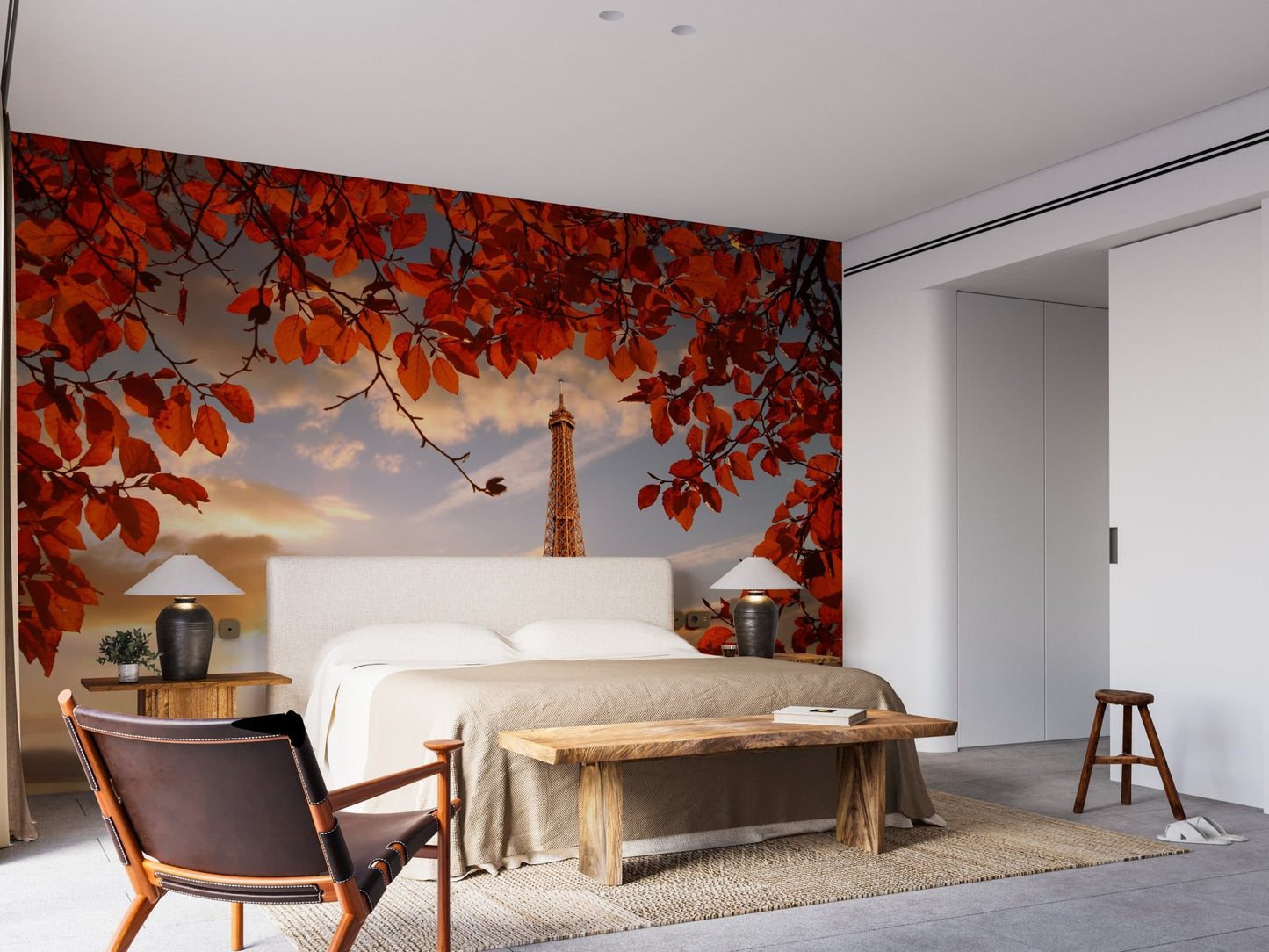 Paris landmark wall mural in a bedroom featuring a wooden bed and leather chair.